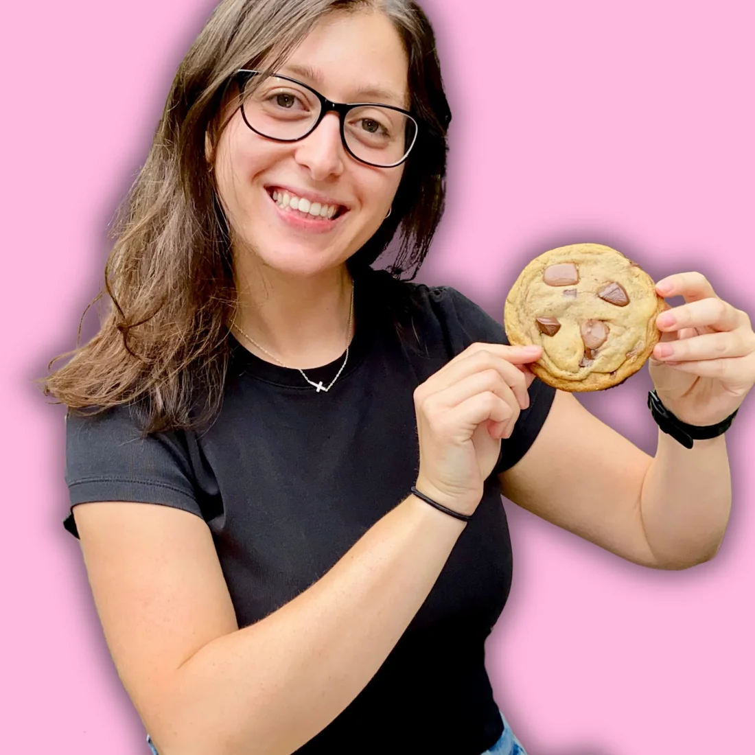Nefeli holding up a chocolate chunk cookie