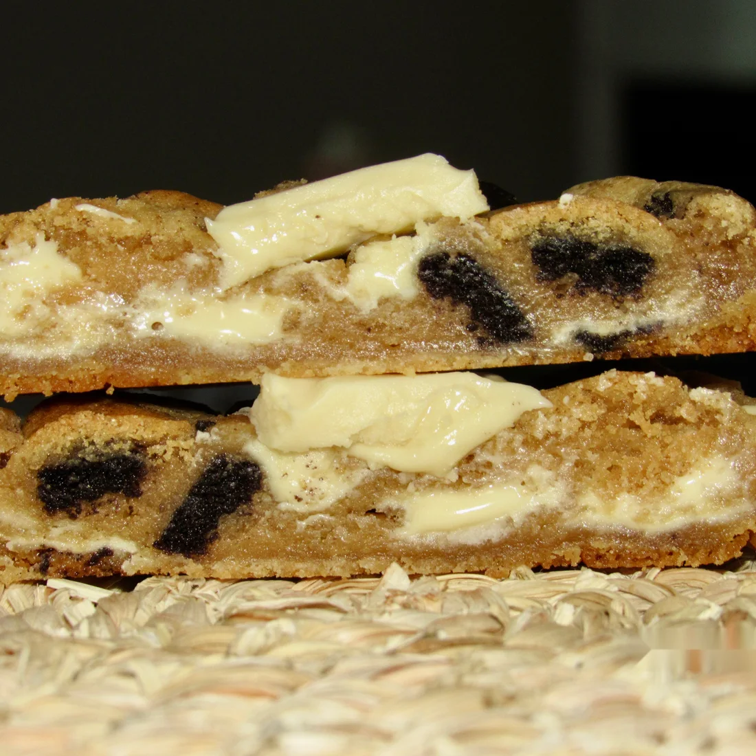 Halved Cookies and Cream cookies stacked to show gooey centres